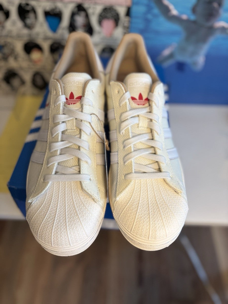 Adidas Superstar, distinguished by its textured fabric upper and red side lettering