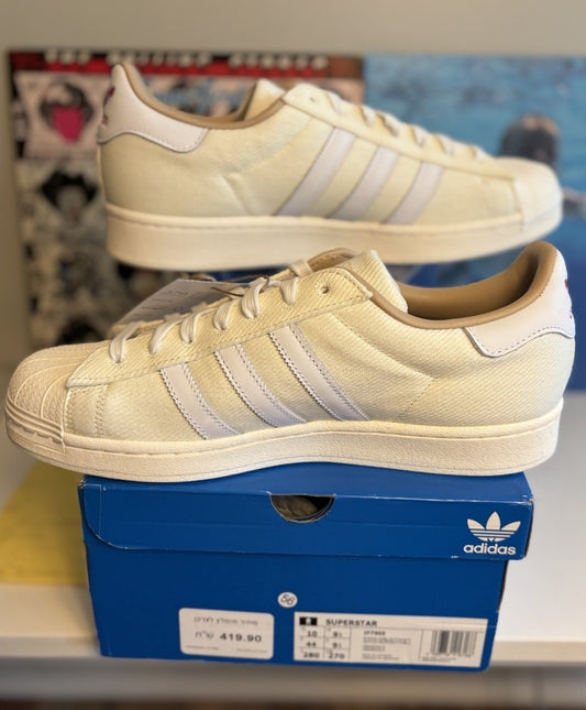 Adidas Superstar, distinguished by its textured fabric upper and red side lettering