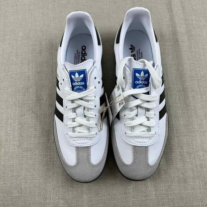 The Adidas Originals Samba OG sneaker features a crisp white leather upper accented by black serrated three-stripes and a classic translucent gum rubber sole
