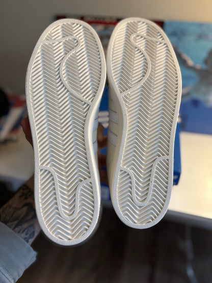 Adidas Superstar, distinguished by its textured fabric upper and red side lettering