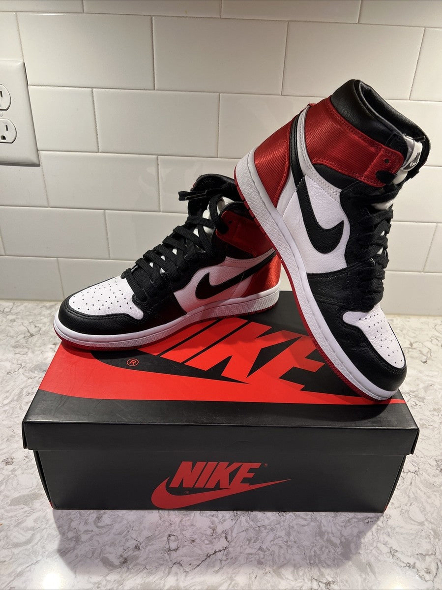 Jordan 1 Retro High OG 'Satin Black Toe', showcasing a lustrous red